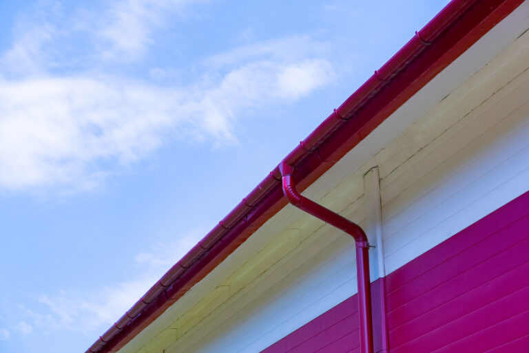 Red gutter on the roof top of house